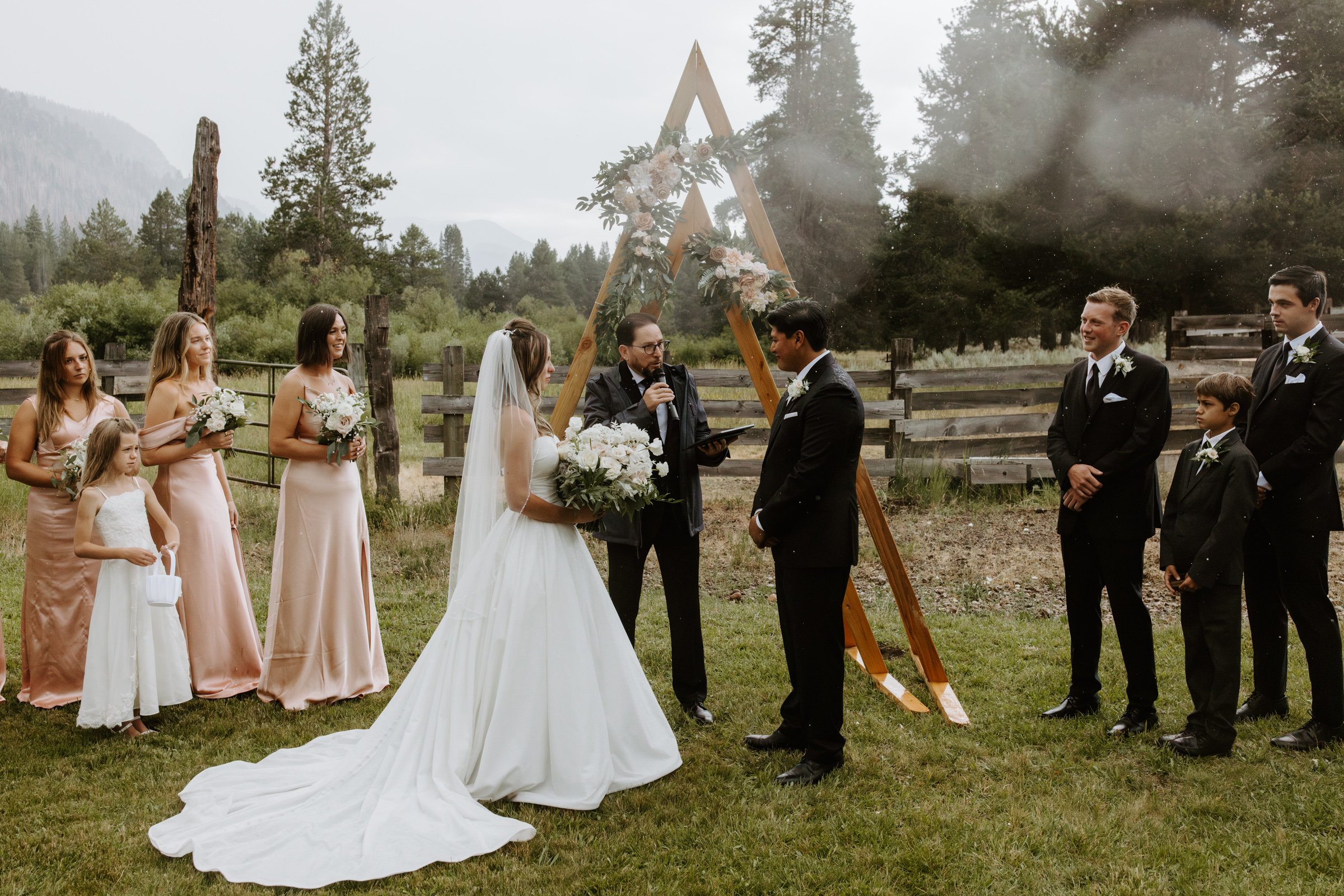 Bride and groom standing at the altar during their intimate wedding ceremony in Lake Tahoe, exchanging vows with a stunning scenic backdrop.