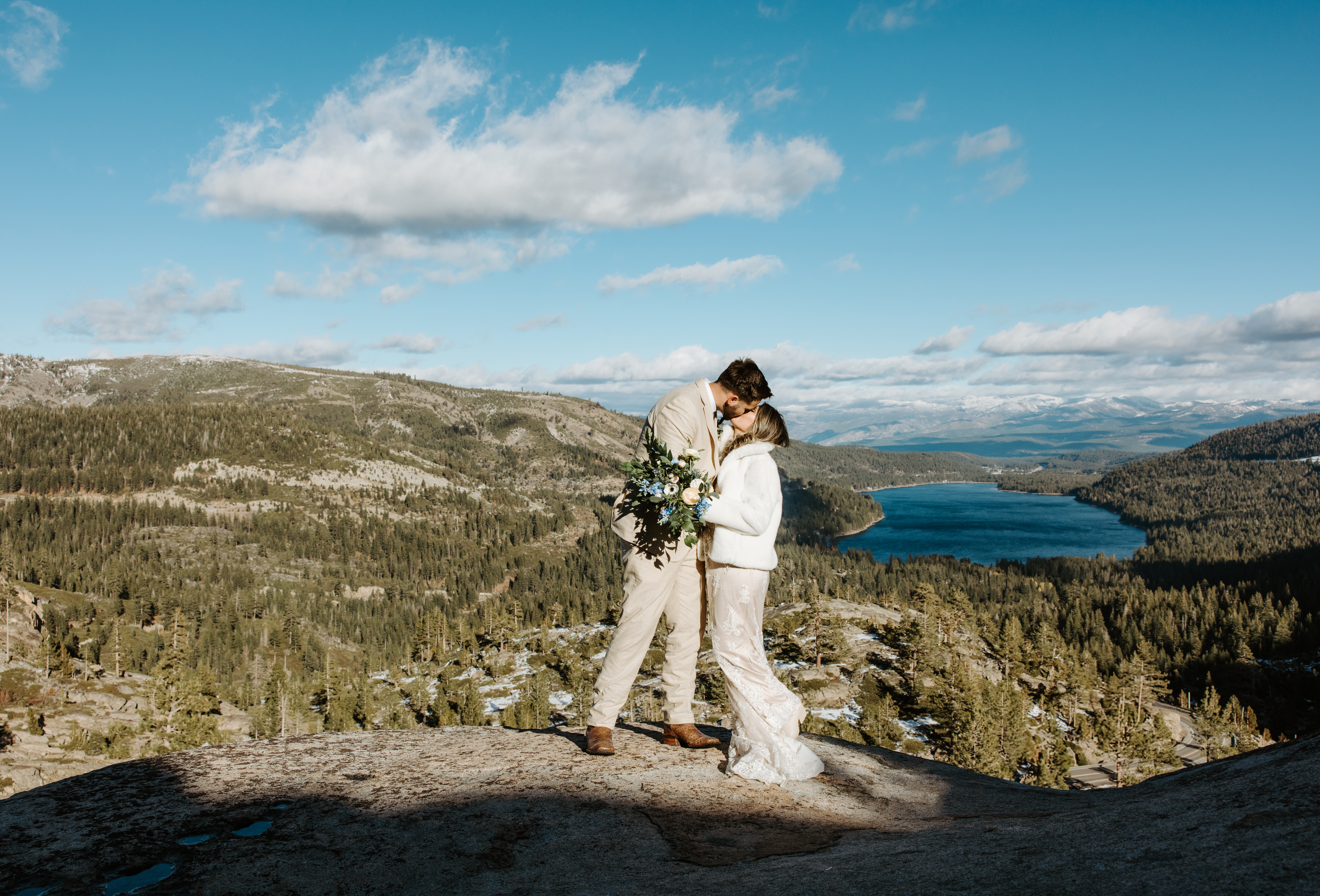 A couple sharing a kiss at their intimate Lake Tahoe elopement above Donner Lake, showcasing the breathtaking scenery of the Sierra Nevada mountains.