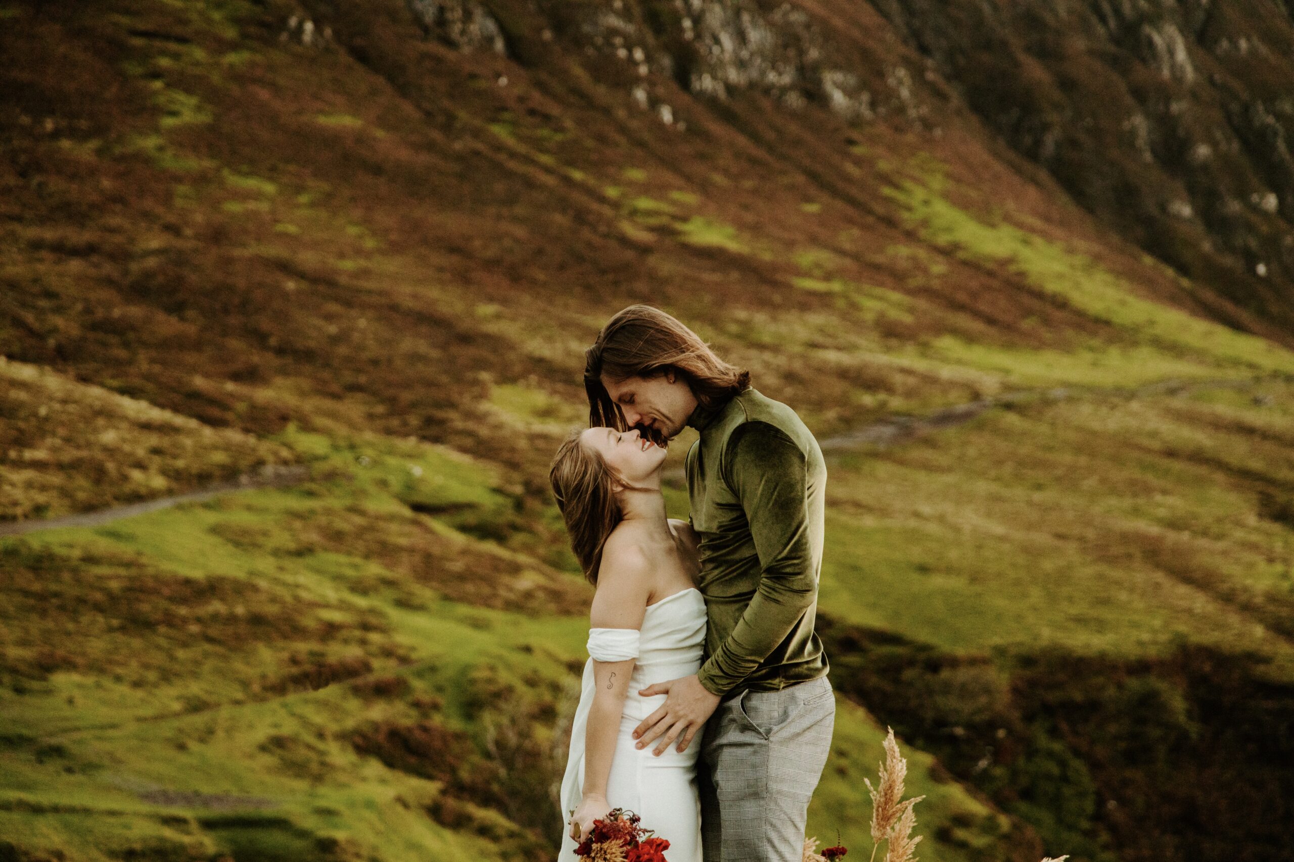 Bride and groom pausing to take in the breathtaking view of the Quiraing during their adventure elopement.