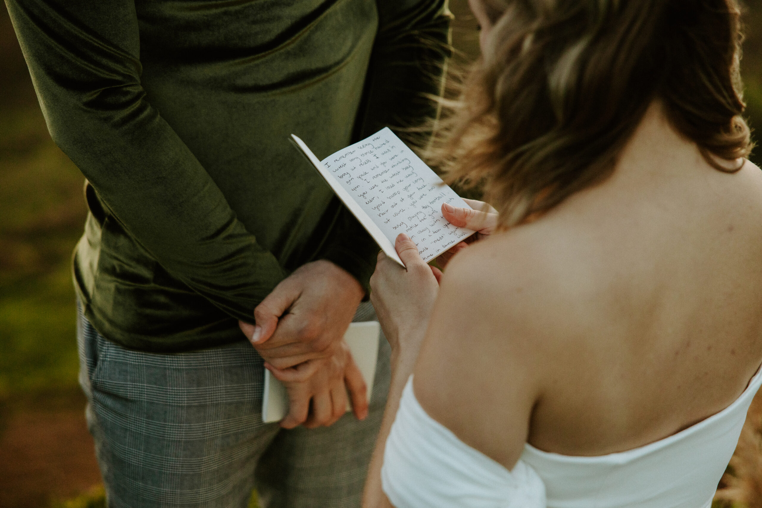 A heartfelt moment as the couple reads their vows to each other, standing amidst the breathtaking scenery of Scotland, their love story unfolding in the most intimate way.