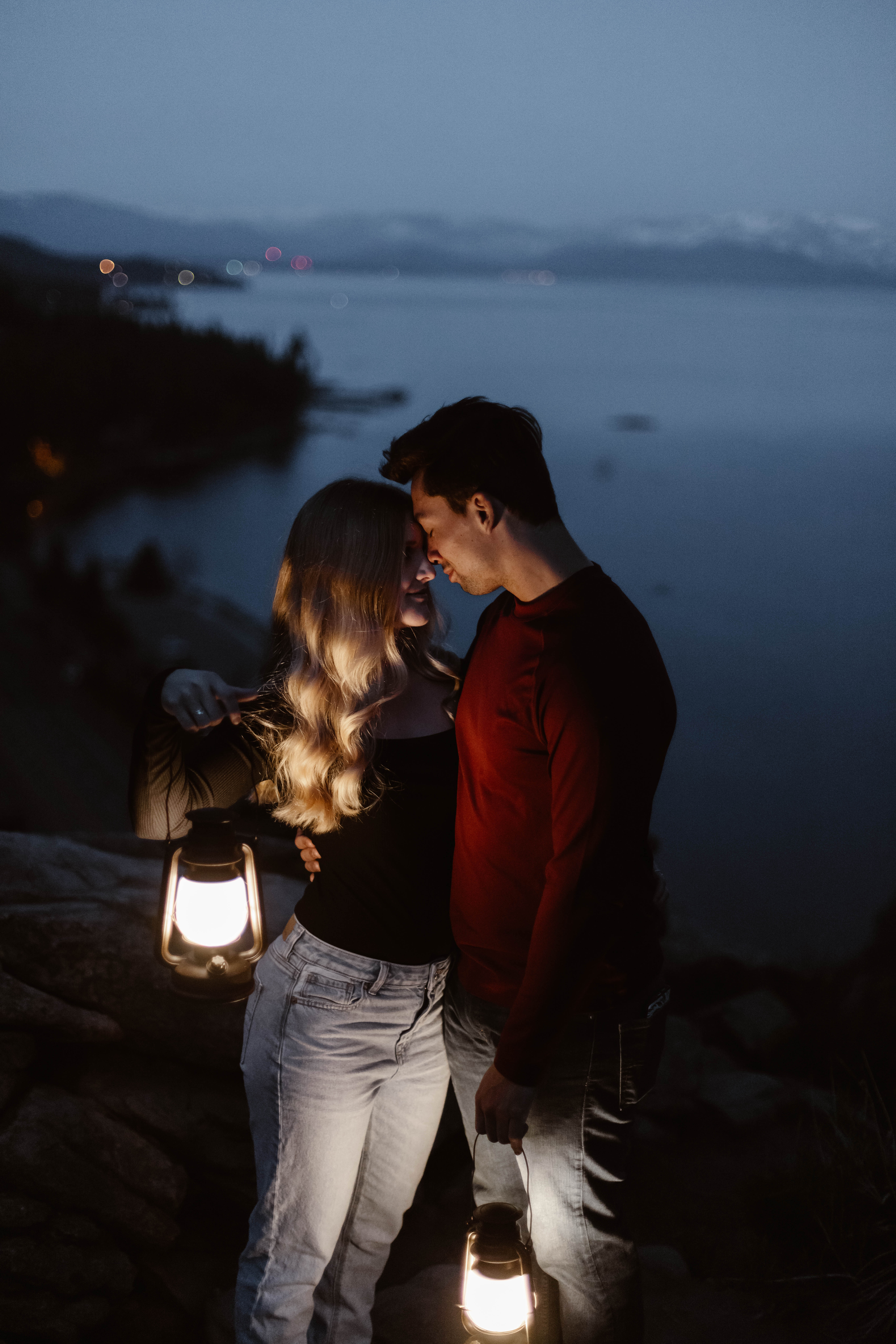 Captured during the enchanting blue hour, this photograph features a couple bathed in the soft glow of lantern light. The tranquil and romantic moment is a testament to the photographer's skill and artistry.