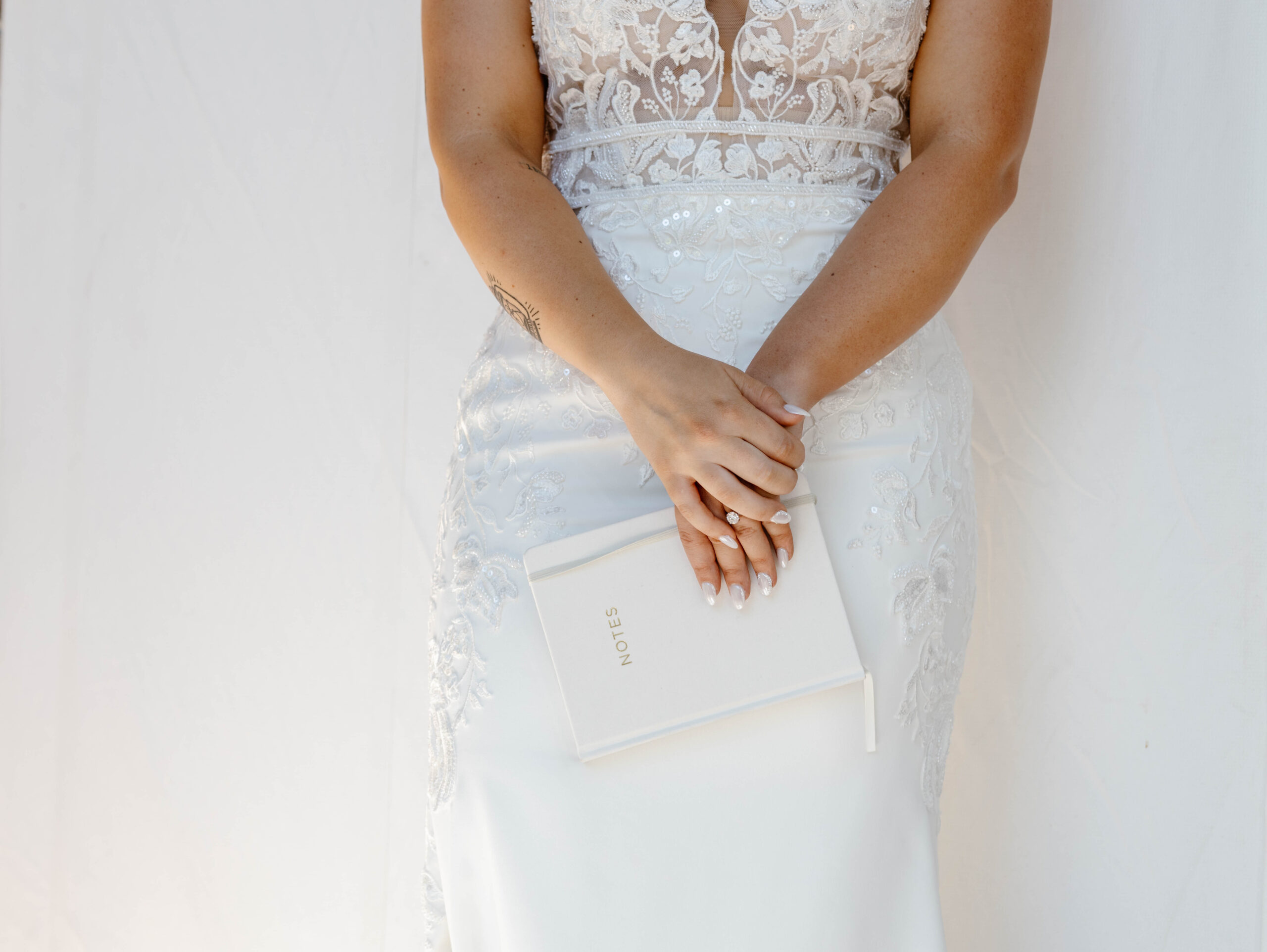 bride holding vow book moments before walking down the aisle 