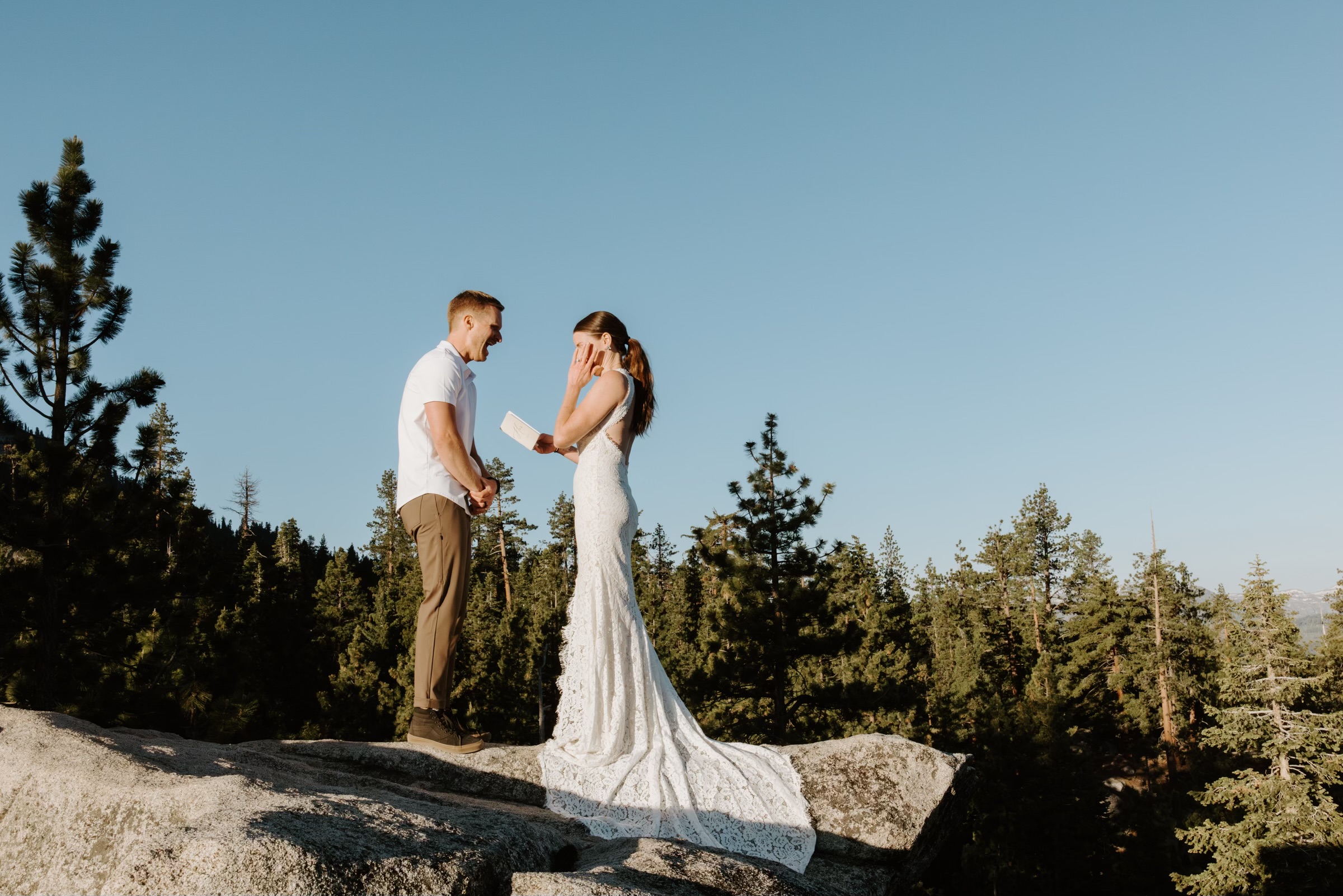 couple share private vow reading high above lake tahoe in the forest