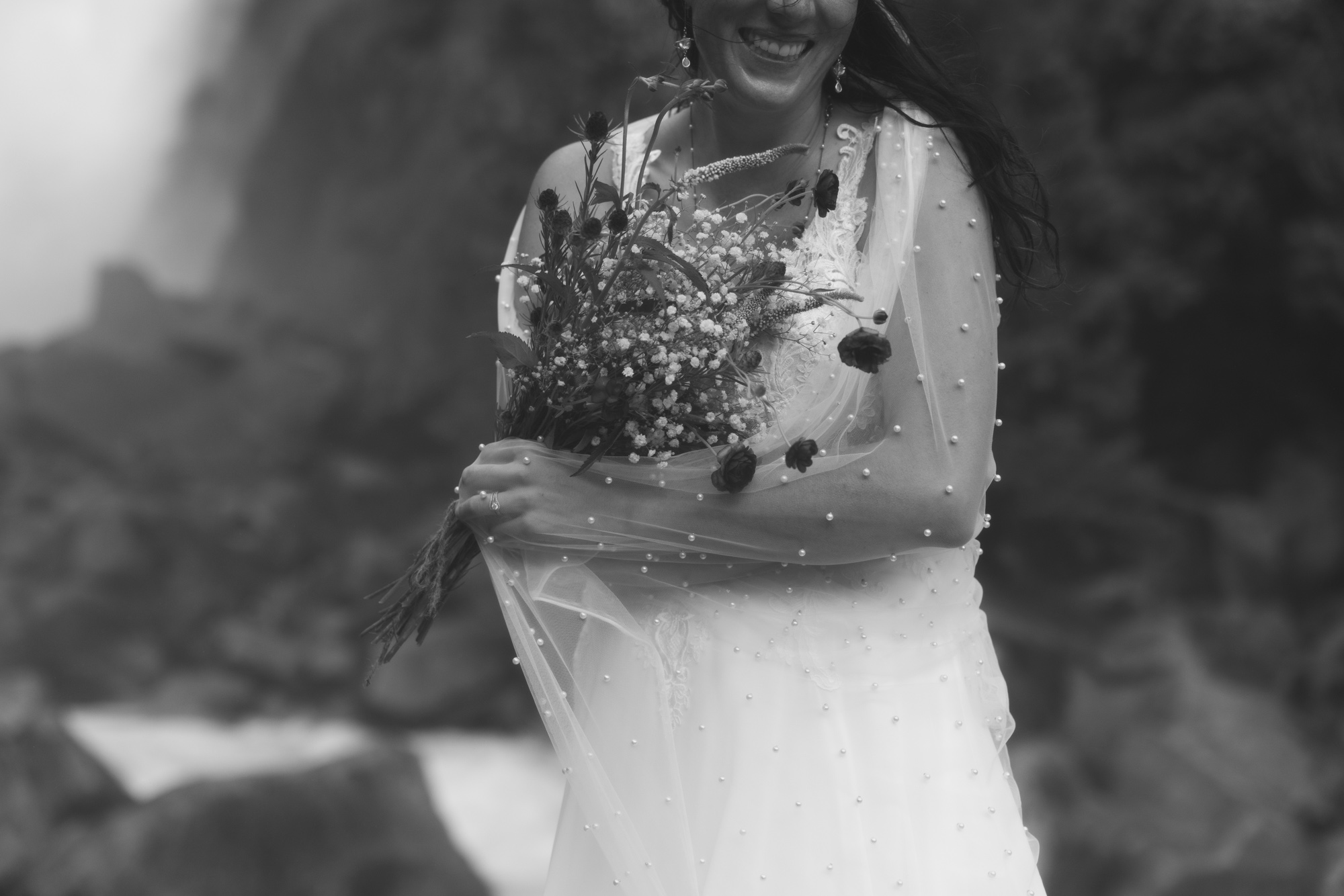Bride feeling the mist of Yosemite Falls