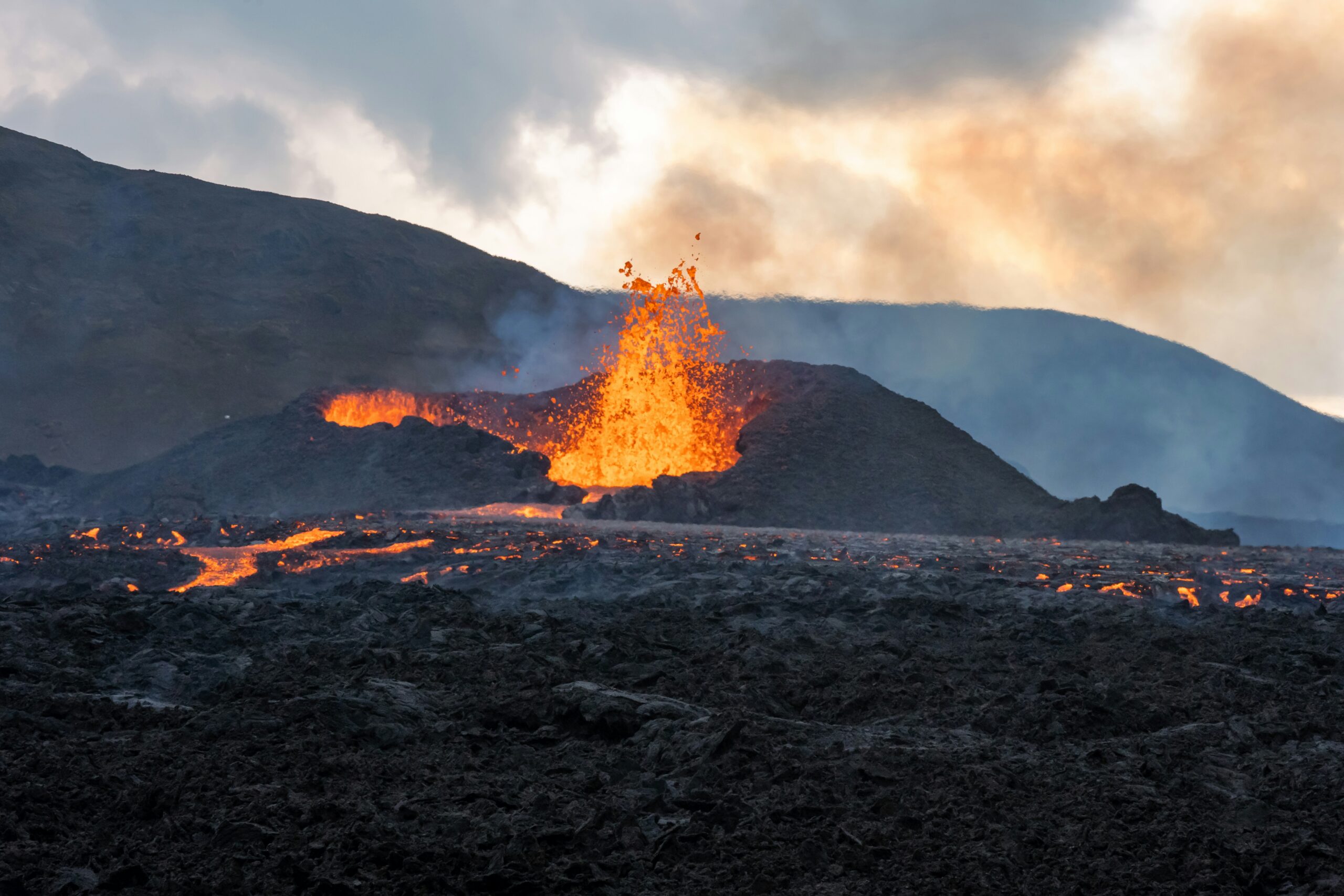 Lava-lit cliffs at sunset in Hawaii Volcanoes National Park, an epic and dramatic location for adventurous elopements.